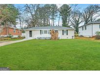 Ranch style home with a spacious lawn and mature trees at 2490 Habersham Dr, Decatur, GA 30032