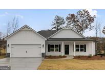 Newly constructed home with white siding, a two-car garage, and landscaping at 8950 Callaway Drive, Winston, GA 30187