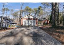 Brick ranch home with attached two-car garage and long driveway at 3153 Sweetbriar Dr, Villa Rica, GA 30180