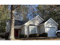Tan house with red door, attached garage, and landscaping at 3700 Mays Sw Xing, Atlanta, GA 30331
