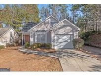 Charming single Gathering home with attached garage, mature landscaping, and a concrete walkway at 3700 Mays Sw Xing, Atlanta, GA 30331