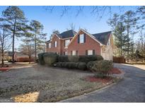 Brick house with two-car garage and manicured lawn at 5247 Hayden Farms Dr, Powder Springs, GA 30127