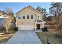 Inviting two-story home features a neutral color scheme, well-manicured lawn, and an attached two-car garage at 429 Burgundy Se Ter, Atlanta, GA 30354