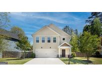 Two-story house with a two-car garage and a well-maintained lawn at 429 Burgundy Se Ter, Atlanta, GA 30354