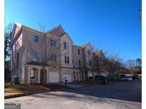 Brick townhome with attached garage and ample parking at 4879 Pinnacle Dr, Stone Mountain, GA 30088