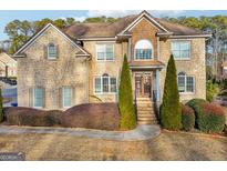Two story house with stone accents and landscaping at 408 Edmond Ct, Suwanee, GA 30024