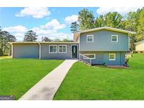 Gray exterior house with landscaped lawn and walkway at 3245 Bunny Ln, Decatur, GA 30034
