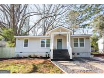Charming house with gray siding, a teal door, and landscaped yard at 3377 Phillips Cir, Decatur, GA 30032