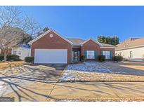 Brick ranch house with attached garage and landscaped yard at 325 Autumn Glen Cir, Fayetteville, GA 30215