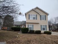 Two-story house with beige vinyl siding, and a partially visible basketball goal at 4635 Duration Ct, Snellville, GA 30039