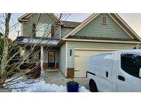 Two-story house with gray siding, a two-car garage, and a small front porch at 2408 Centenary Way Ct, Dacula, GA 30019
