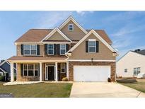 Two story house with a large front yard and driveway at 1009 S. Creek, Villa Rica, GA 30180