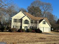 Two-story house with attached garage and landscaping at 4010 Peachtree Farms Rd, Rex, GA 30273