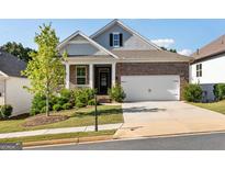Brick and shingle ranch home with two-car garage and landscaped yard at 113 Overlook Ridge Way, Canton, GA 30114