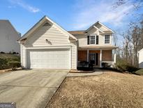 Charming two-story home with a brick facade and a two-car garage at 1535 Valley Club Dr, Lawrenceville, GA 30044