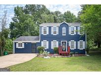 Two-story blue house with white shutters, red steps, and a grassy yard at 2578 Shadowbrook Dr, Decatur, GA 30034