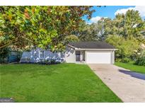 Newly renovated ranch home with a large yard and attached garage at 6595 Bellburn Rd, Atlanta, GA 30349