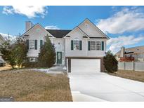 Two-story house with a two-car garage and manicured lawn at 221 Stagecoach Pass, Temple, GA 30179