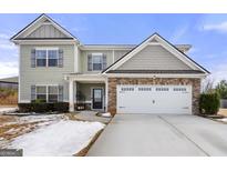Two-story house with stone accents and a three-car garage at 120 Emerson Trl, Covington, GA 30016