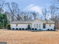 Newly renovated ranch home with a large backyard and modern exterior at 1200 Mount Carmel Rd, Mcdonough, GA 30253