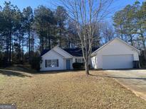 Ranch style home with attached garage and spacious yard at 216 Cane Se Ave, Social Circle, GA 30025