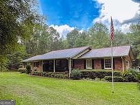 Brick ranch house with covered porch and large yard at 235 Butler Bridge Dr, Mcdonough, GA 30252