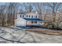 Two-story house with attached garage and porch at 169 Holly Ct, Loganville, GA 30052