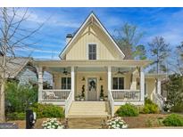Charming yellow cottage with wraparound porch and landscaped yard at 11190 Serenbe Ln, Chattahoochee Hills, GA 30268