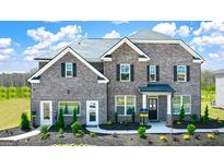 Two-story brick home with a landscaped yard and attached garage at 113 Broder Farms Dr # 387, Stockbridge, GA 30281