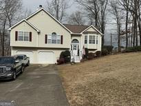 Two-story house with attached garage and landscaped yard at 228 Cornell Ct, Villa Rica, GA 30180
