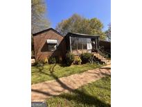 Brick ranch home with sunroom and landscaped yard at 426 E Rhinehill Se Rd, Atlanta, GA 30315