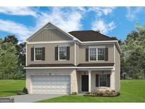Two-story house with a neutral color scheme and a two-car garage at 1480 Trellis Court (Lot 42), Hampton, GA 30228