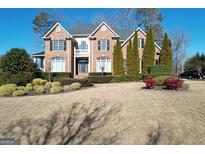 Brick two-story house with landscaped yard and driveway at 7631 Garland Cir # 4, South Fulton, GA 30349