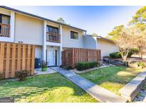 Two-story townhouse with wooden fence and small front yard at 172 Twiggs Cor, Peachtree City, GA 30269