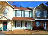 Three-unit townhouse complex with appealing exterior finishes and landscaping at 316 Quincy Ave, Mcdonough, GA 30253