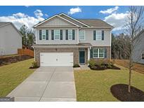 Two-story house with gray siding, brick accents, and a two-car garage at 6817 Chataran Dr, Lithia Springs, GA 30122