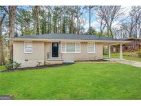 Brick ranch house with a carport and a well-maintained lawn at 4303 Mercer Rd, Decatur, GA 30035