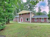 Brick house with red door and large yard at 3031 Golden Dr, East Point, GA 30344