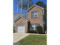 Brick two-story house with attached garage and landscaped lawn at 530 Shadowmoore Dr, Riverdale, GA 30274