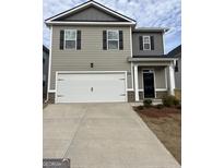 Charming two-story home featuring a two-car garage and a welcoming front porch at 12029 Conrad Circle, Hampton, GA 30228