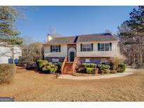 Two-story house with stone accents and a landscaped yard at 90 Cypress Dr, Covington, GA 30016