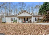 Ranch style home with covered porch and large yard at 304 Slaughter Rd, Hampton, GA 30228