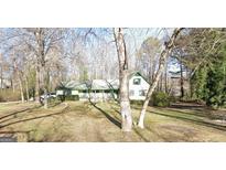 Ranch home with a large front yard and mature trees at 9266 Brave Ct, Jonesboro, GA 30236