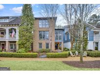 Beautiful brick home with manicured landscaping, mature trees, and inviting front entrance at 147 Hubbard Rd, Woodstock, GA 30188