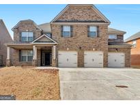 Charming brick home featuring a three-car garage and well-maintained front yard at 1225 Polk Xing, Mcdonough, GA 30252