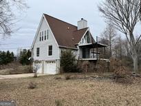 A-frame house with two-car garage and deck at 985 Colvin Dr, Locust Grove, GA 30248