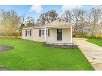 Newly renovated brick ranch home with a covered porch and well-manicured lawn at 1876 Flat Shoals Se Rd, Atlanta, GA 30316