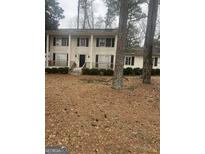Two-story house with front porch, surrounded by mature trees at 1708 S Deshon Rd, Lithonia, GA 30058