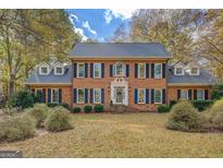 Brick two-story home with a large front yard and mature trees at 960 Todd Dr, Covington, GA 30014