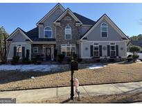 Two-story house with gray siding, stone accents, and a landscaped lawn at 100 Harmony Ct, Dallas, GA 30157